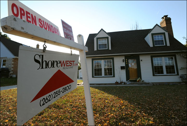 A for sale sign stands in front of a foreclosed home at 543 N. 97th St. in Wauwatosa on Monday. (Photo by Kevin Harnack)