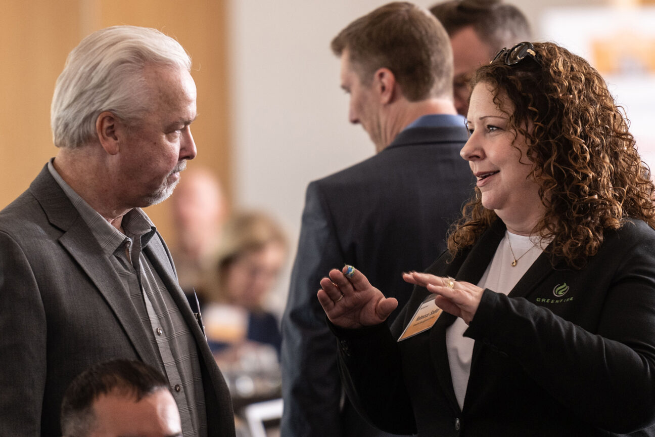 Bert Zenker of MSI General (left) and Rebecca Sadler of Greenfire Management Services talk before the start of the program. 