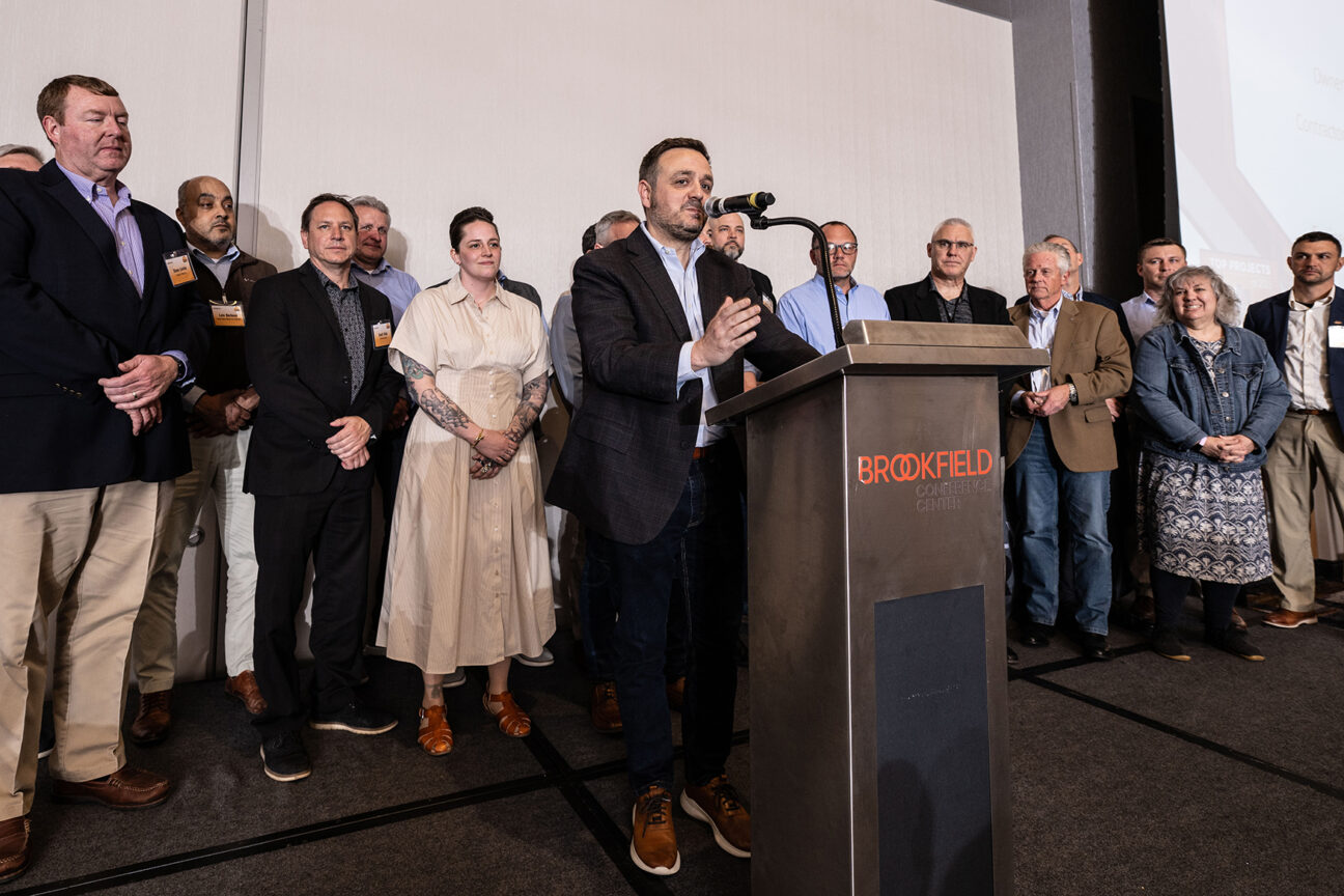 Representatives of Hunzinger, EAU, Pierce Engineers, Ring & DuChateau, GESTRA and other project partners gather behind Chad Bauman, executive director of the Milwaukee Repertory Theater, after the project was honored with Best in Show (Project of the Year) at the end of the night.