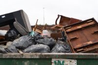 Community members bring trash and flood damaged belongings to Milwaukee’s drop-off center in West Milwaukee on the morning of Aug. 12, 2025. The city’s two drop-off centers are free of charge through Aug. 17.