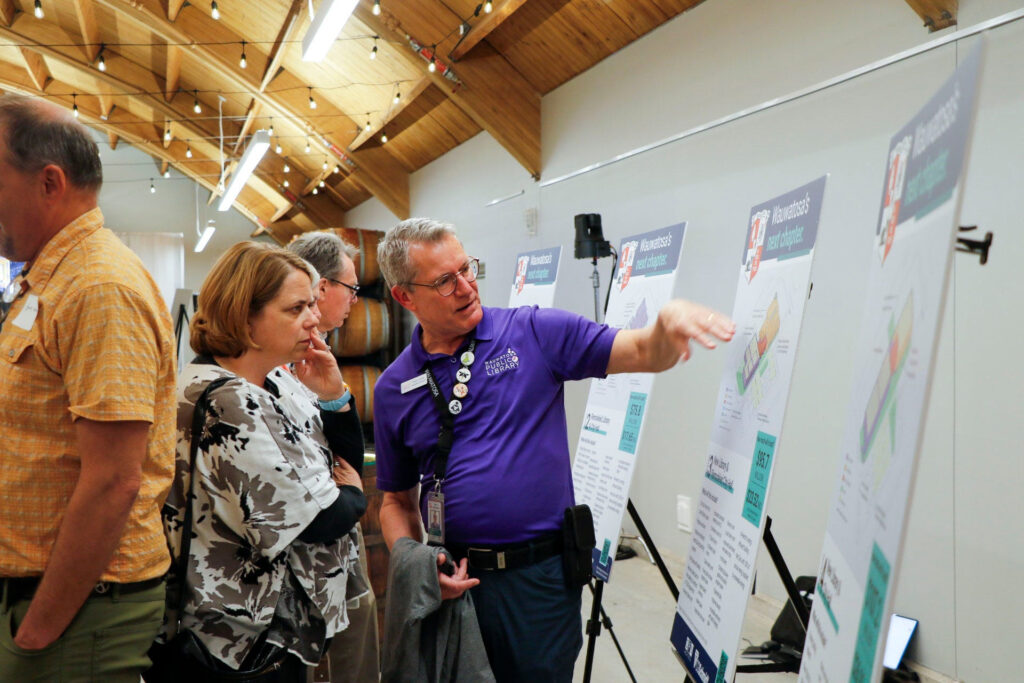 Robert Trunley, Wauwatosa's assistant library director, tells a resident about the new options the city is weighing for library and city hall renovations at the Wauwatosa State of the City address, which occurred May 14 at the Muellner Building in Hart Par